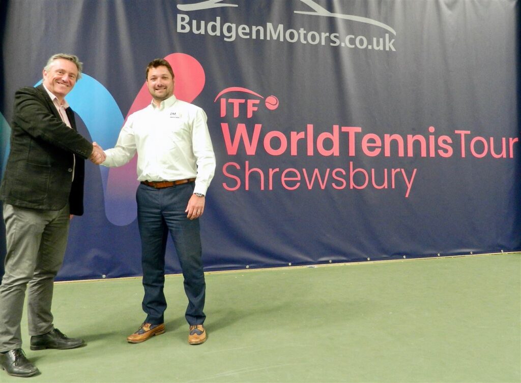 Dave Courteen and Stuart Danks in front of ITF World Tennis Tour Shrewsbury sign