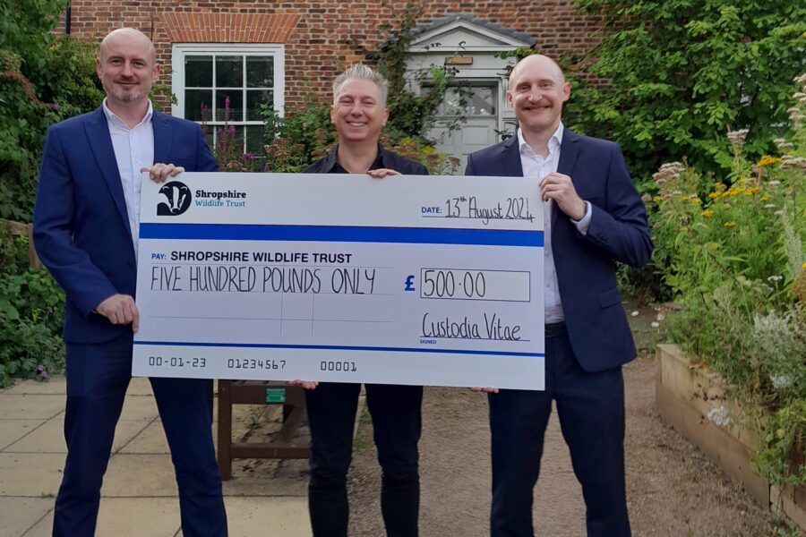 Neil Cowan and James Richards from DMOS People with Craig Baker from Shropshire Wildlife Trust outside holding a large cheque
