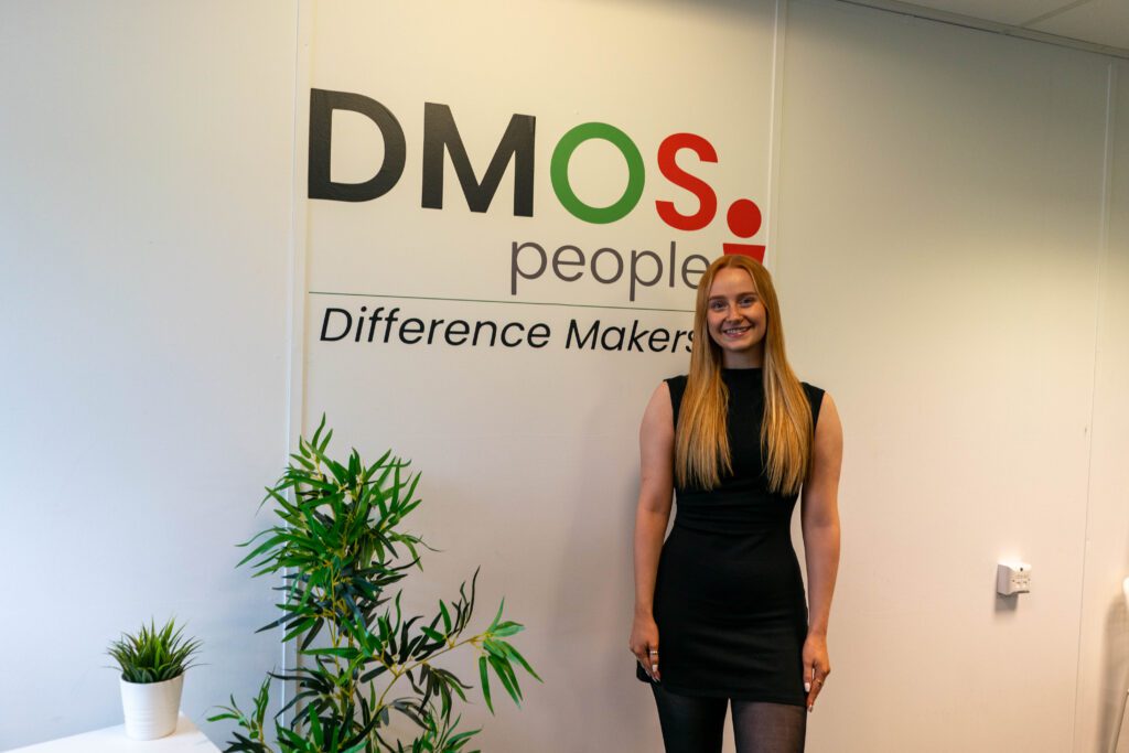 Charlotte in front of a DMOS People sign